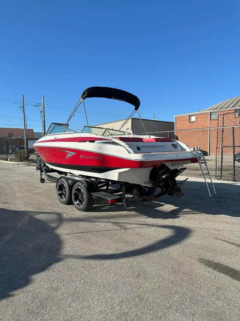 Slide: The Image of 2025 Crownline 240 SS boat with red and white design on a trailer. - 7