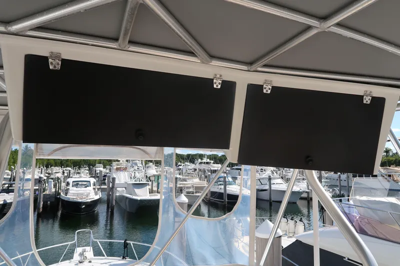 Slide: The Image of Luhrs 40 Convertible 2002 boat with marina view, featuring overhead compartments. - 17