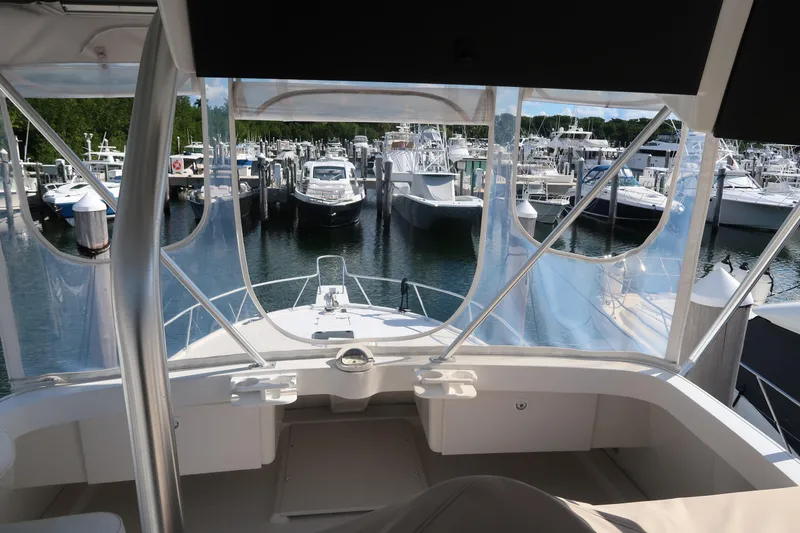 Slide: The Image of 2002 Luhrs 40 Convertible yacht docked at a marina, surrounded by other boats. - 20