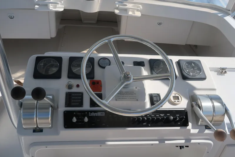 Slide: The Image of 2002 Luhrs 40 Convertible helm with steering wheel and control panel. - 21