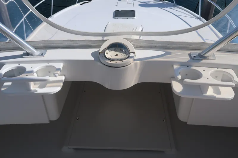 Slide: The Image of Luhrs 40 Convertible 2002 boat deck with compass and cup holders. - 24
