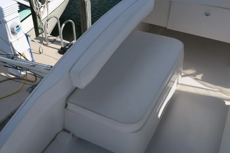 Slide: The Image of Luhrs 40 Convertible 2002 boat seating area with white cushions. - 25