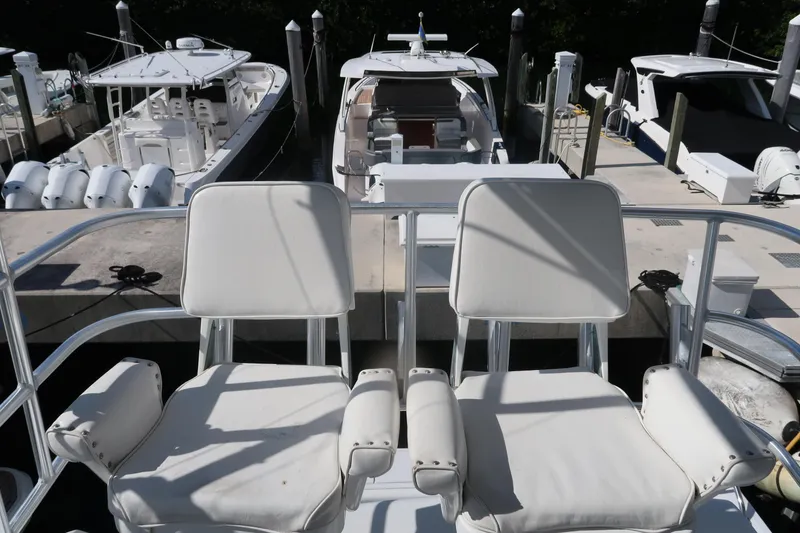 Slide: The Image of 2002 Luhrs 40 Convertible yacht with white seating at a marina dock. - 28
