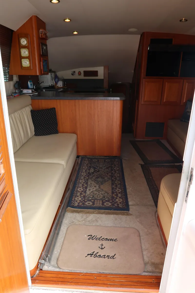 Slide: The Image of Interior of 2002 Luhrs 40 Convertible yacht with cozy seating and welcome mat. - 30