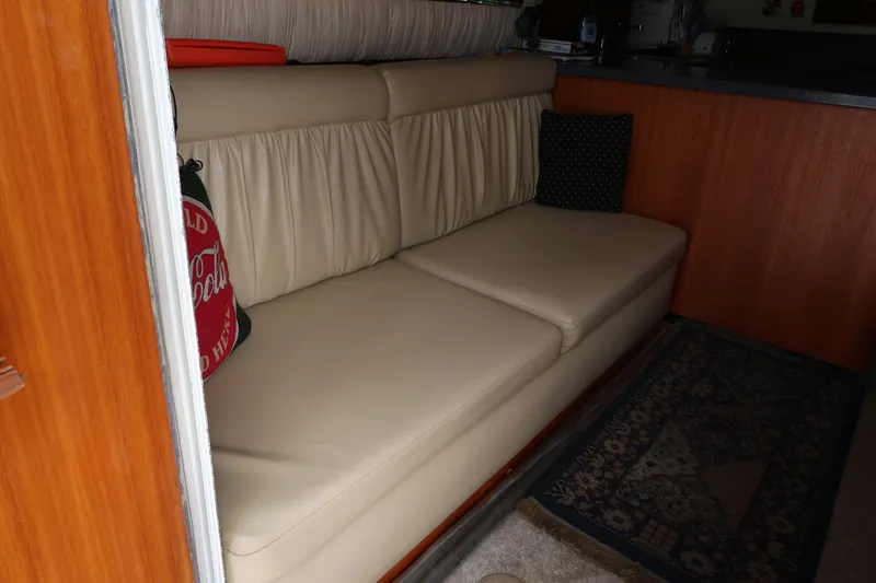 Slide: The Image of Interior of 2002 Luhrs 40 Convertible with beige leather sofa and decorative pillows. - 31