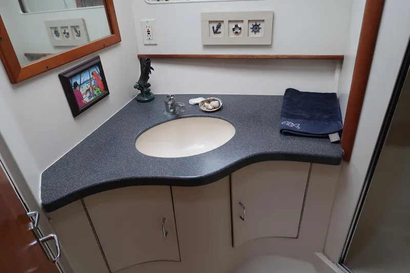 Slide: The Image of 2002 Luhrs 40 Convertible bathroom with curved countertop and sink. - 34