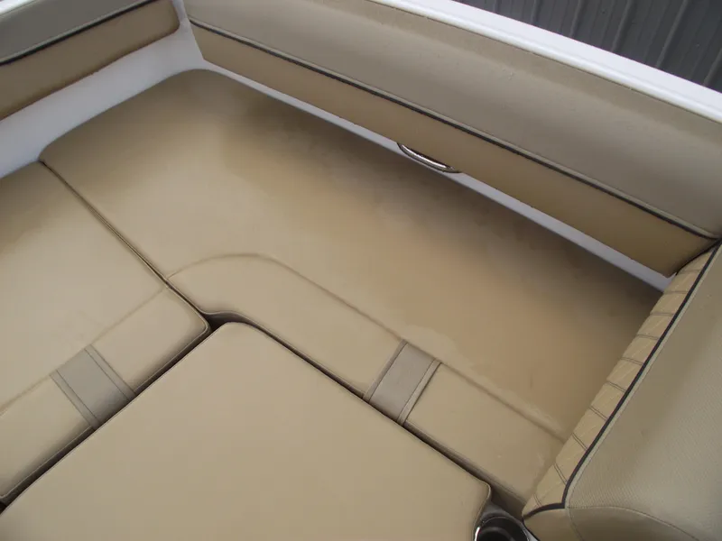 Slide: The Image of 2025 Bayliner D20 boat interior with beige cushioned seating. - 10