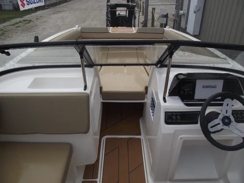 Slide: The Image of 2025 Bayliner D20 boat interior with modern dashboard and seating. - 14