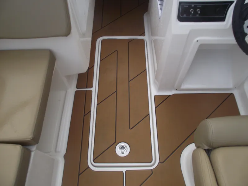 Slide: The Image of 2025 Bayliner D20 interior with tan cushioned seating and sleek flooring design. - 18