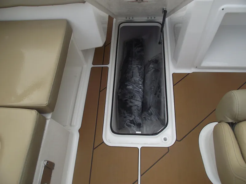 Slide: The Image of 2025 Bayliner D20 boat interior with storage compartment and beige seating. - 19
