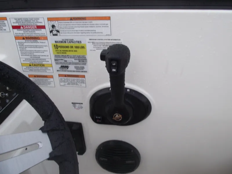 Slide: The Image of Bayliner D20 2025 boat control panel with throttle and warning labels. - 21
