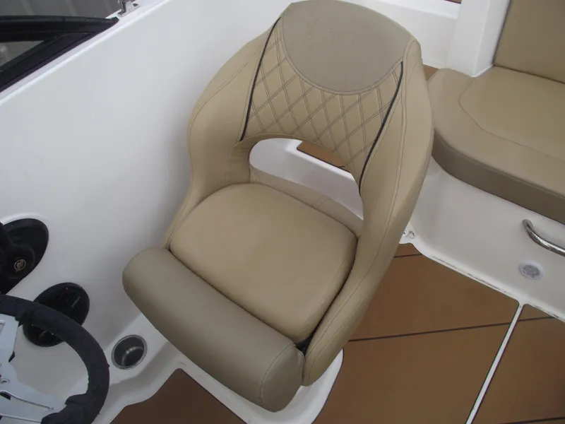 Slide: The Image of 2025 Bayliner D20 boat seat with beige upholstery and diamond stitching. - 22