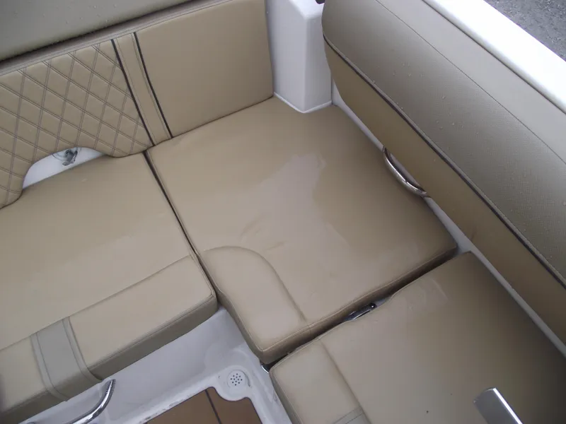 Slide: The Image of 2025 Bayliner D20 boat interior with beige cushioned seating. - 25