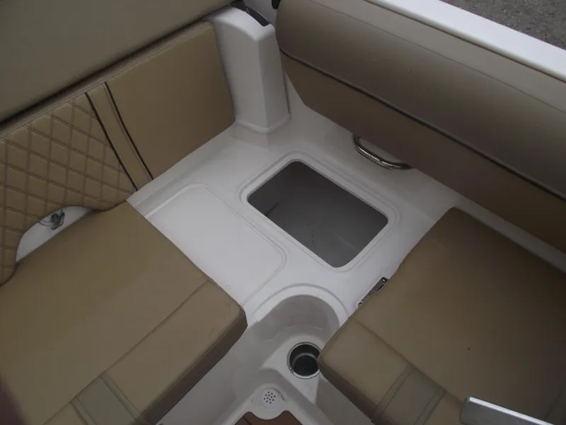 Slide: The Image of 2025 Bayliner D20 boat interior with tan seating and storage compartment. - 26