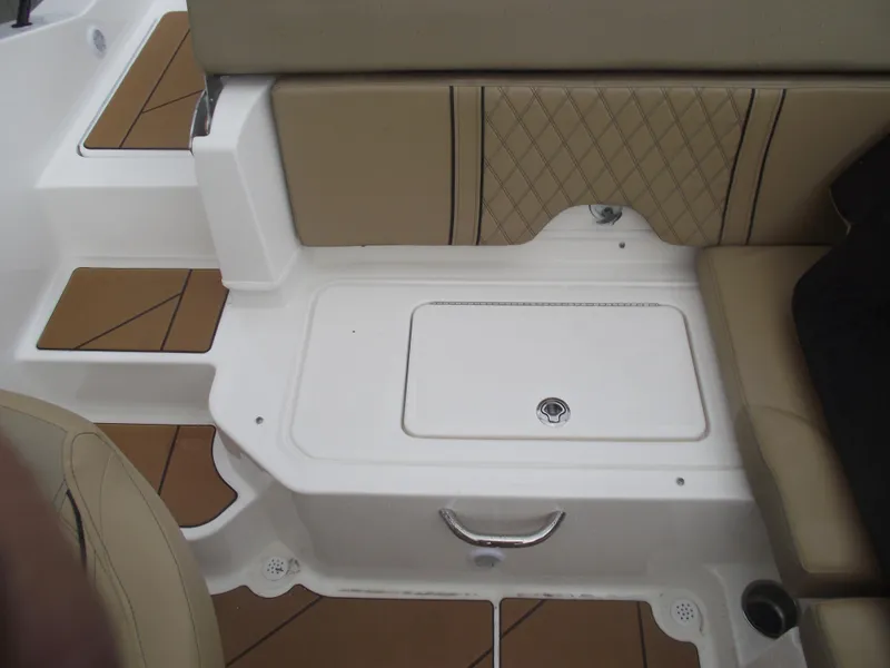 Slide: The Image of 2025 Bayliner D20 boat interior with tan seating and storage compartment. - 28