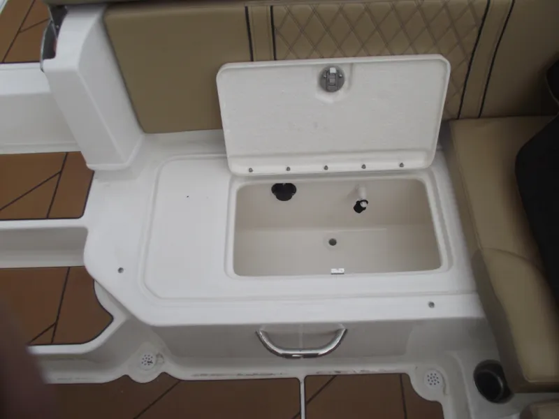 Slide: The Image of 2025 Bayliner D20 boat storage compartment with open lid and beige seating. - 29