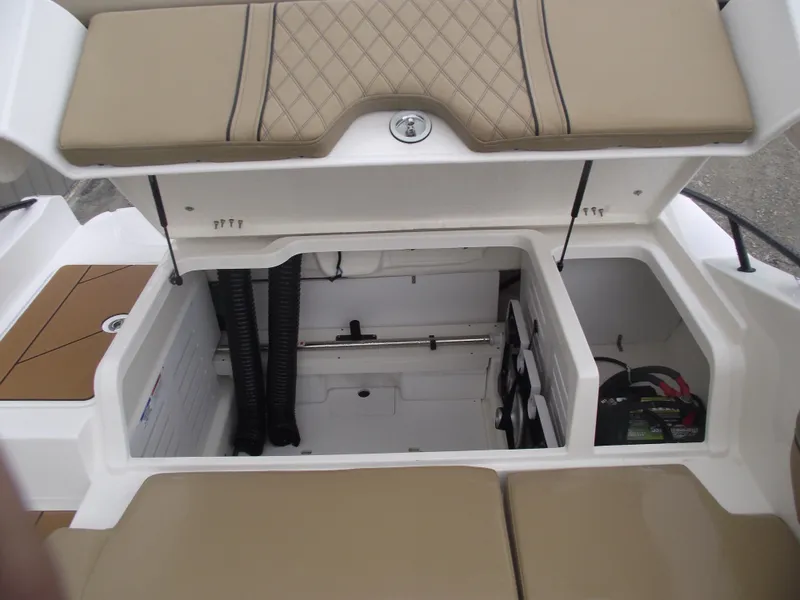 Slide: The Image of 2025 Bayliner D20 boat storage compartment with cushioned seating and battery compartment. - 30