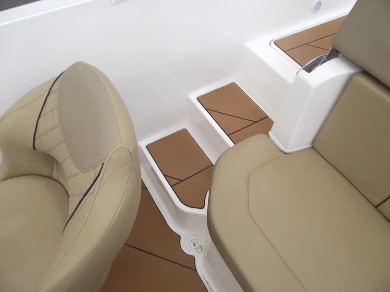 Slide: The Image of 2025 Bayliner D20 interior with beige seating and brown step accents. - 31