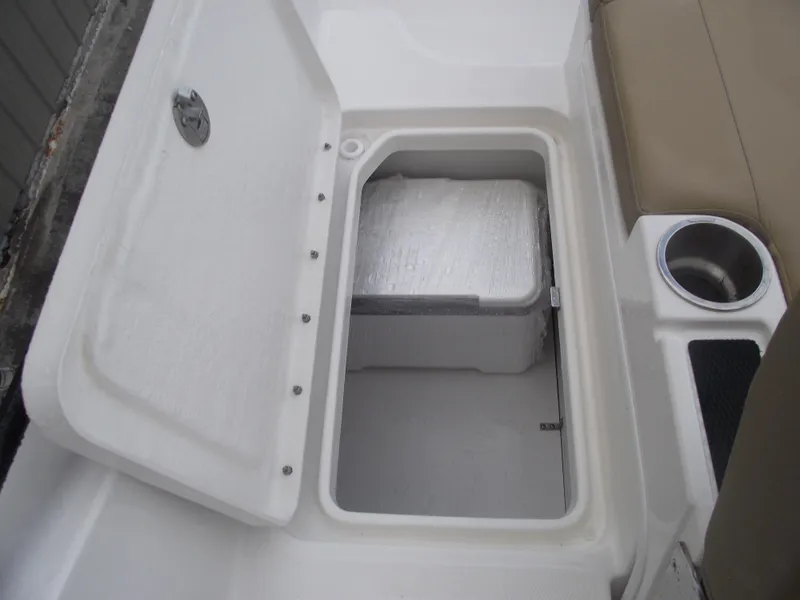 Slide: The Image of Open storage compartment on 2025 Bayliner D20 boat with cup holder. - 33