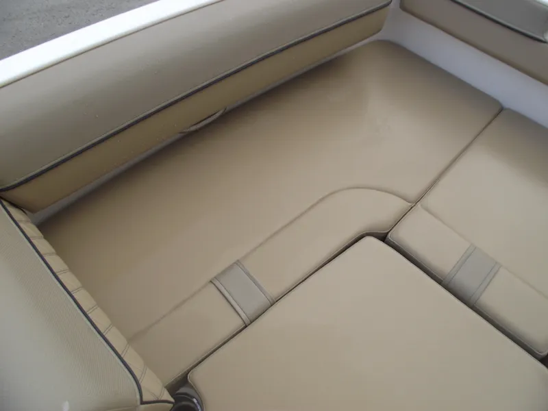 Slide: The Image of 2025 Bayliner D20 boat interior with beige cushioned seating. - 8