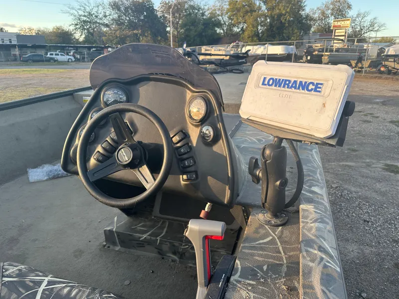 Slide: The Image of 2022 War Eagle 2070 Blackhawk boat dashboard with steering wheel and Lowrance GPS. - 12