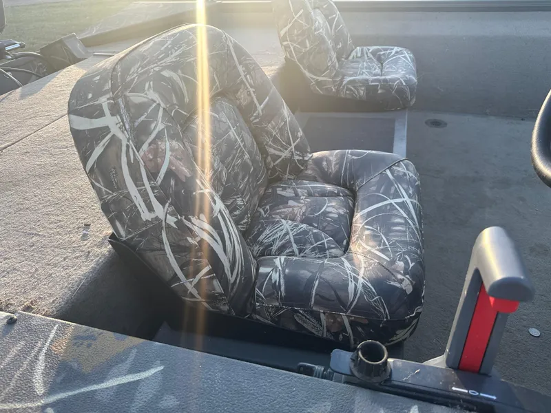 Slide: The Image of Camouflage seats in a 2022 War Eagle 2070 Blackhawk boat, sunlit interior view. - 13