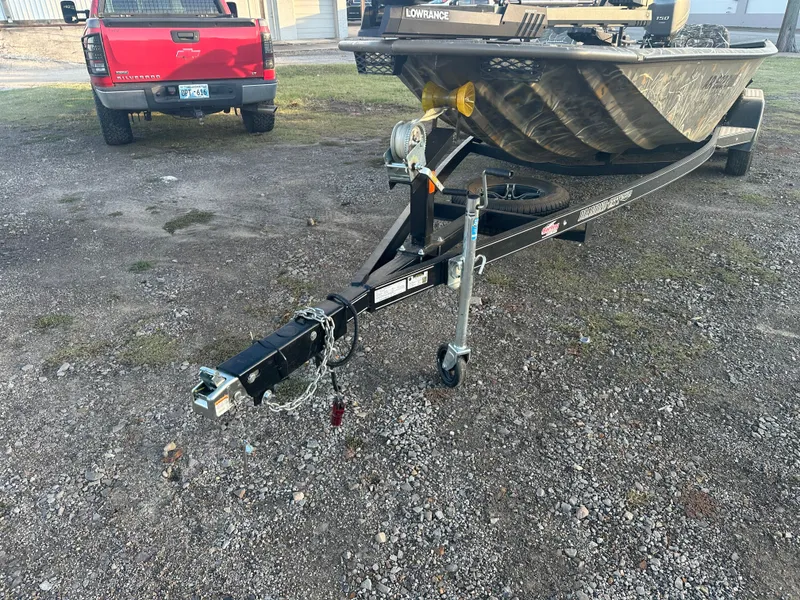 Slide: The Image of 2022 War Eagle 2070 Blackhawk boat on trailer, parked on gravel near red truck. - 14