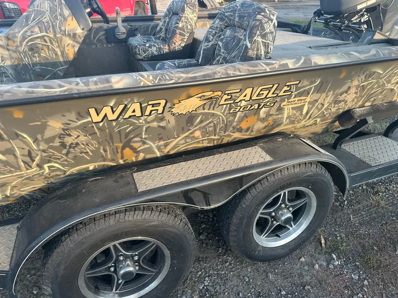 Slide: The Image of 2022 War Eagle 2070 Blackhawk boat with camouflage design on a trailer. - 16