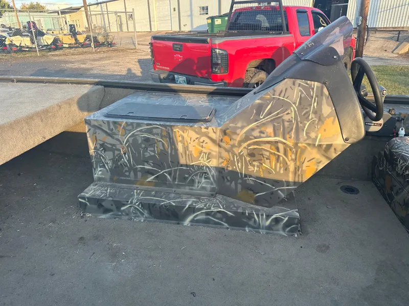 Slide: The Image of 2022 War Eagle 2070 Blackhawk boat interior with camouflage console and steering wheel. - 8