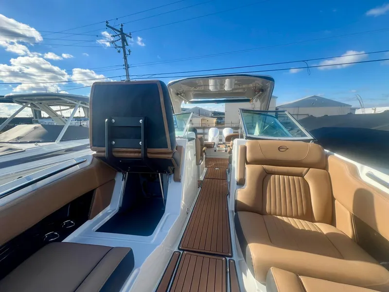Slide: The Image of 2025 Crownline 310 XSS boat interior with tan leather seats and sleek design. - 10