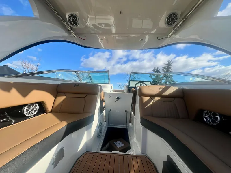 Slide: The Image of Interior view of 2025 Crownline 310 XSS boat with luxurious seating and clear sky. - 17