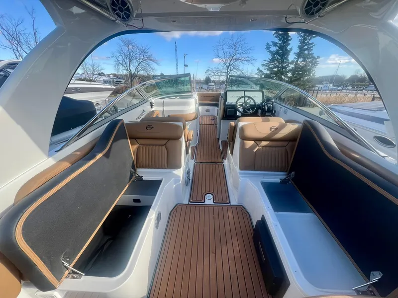 Slide: The Image of 2025 Crownline 310 XSS boat interior with open storage compartments and sleek design. - 20