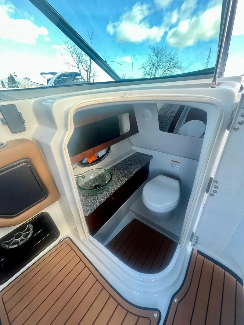 Slide: The Image of 2025 Crownline 310 XSS boat interior with modern bathroom amenities. - 27
