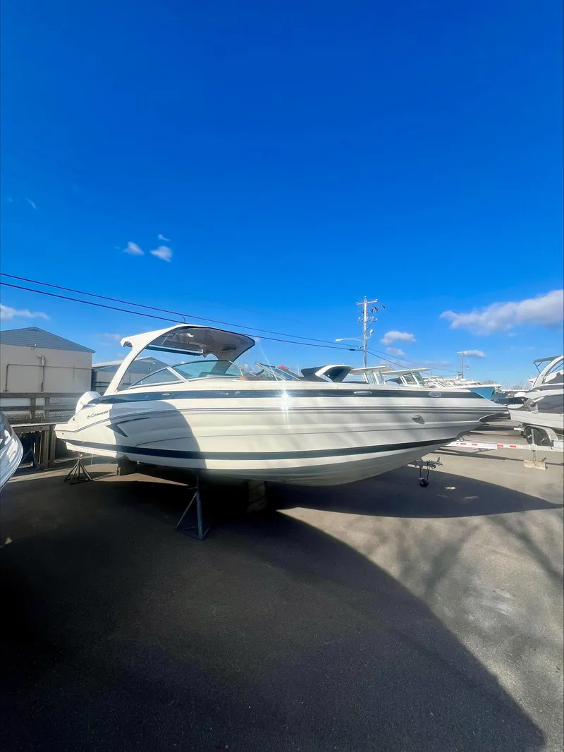 Slide: The Image of 2025 Crownline 310 XSS boat under clear blue sky. - 3