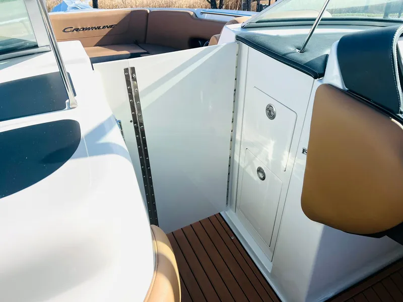 Slide: The Image of 2025 Crownline 310 XSS boat interior with sleek design and wood flooring. - 34