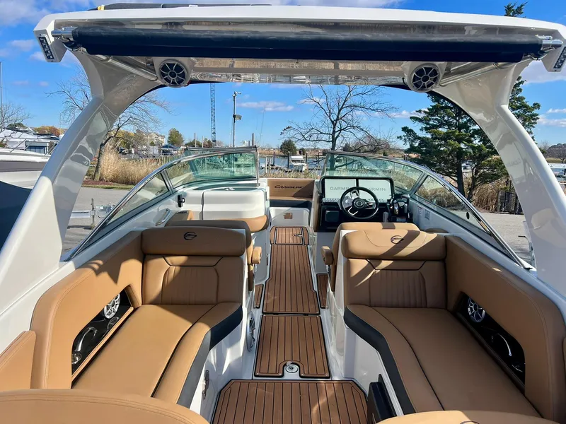 Slide: The Image of 2025 Crownline 310 XSS boat interior with tan seating and sleek design. - 5