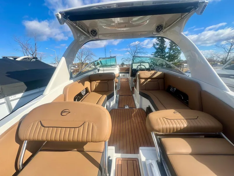 Slide: The Image of Luxurious 2025 Crownline 310 XSS boat interior with tan leather seating and sleek design. - 6
