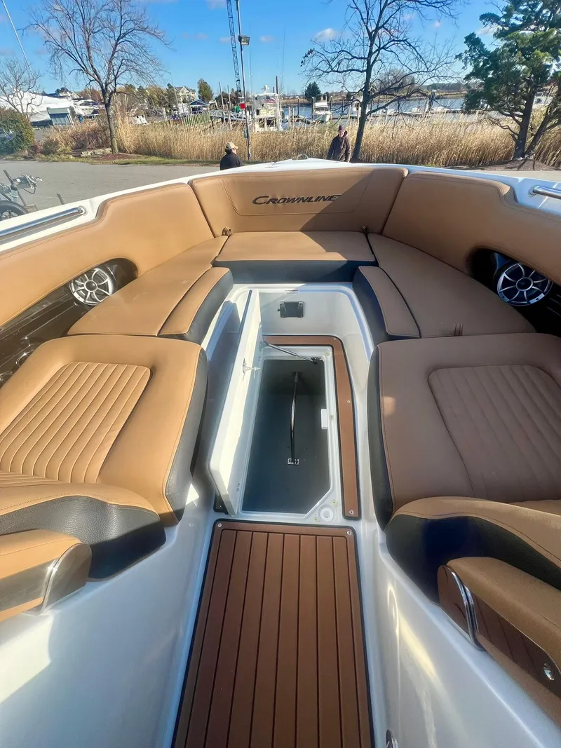 Slide: The Image of Luxurious 2025 Crownline 310 XSS boat interior with tan seating and sleek design. - 8