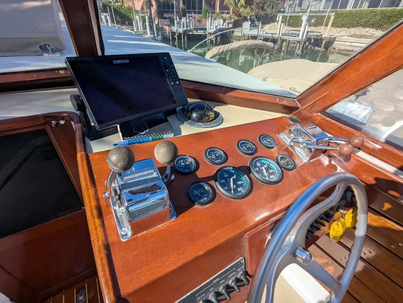 Slide: The Image of 1951 Huckins Fairform Flyer helm with vintage gauges and modern navigation equipment. - 12