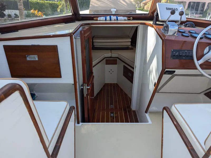 Slide: The Image of 1951 Huckins Fairform Flyer boat interior with wood accents and navigation equipment. - 14