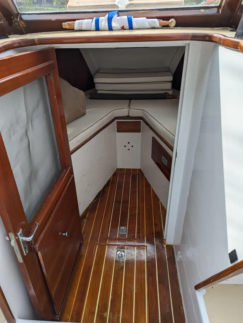 Slide: The Image of 1951 Huckins Fairform Flyer cabin interior with wooden flooring and cushioned seating. - 15