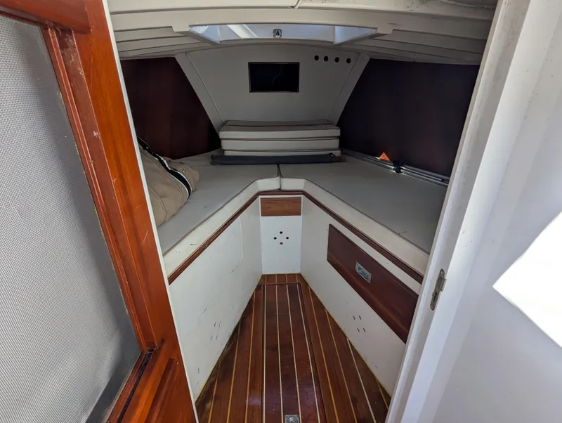 Slide: The Image of Interior cabin of 1951 Huckins Fairform Flyer with wooden flooring and cozy sleeping area. - 16