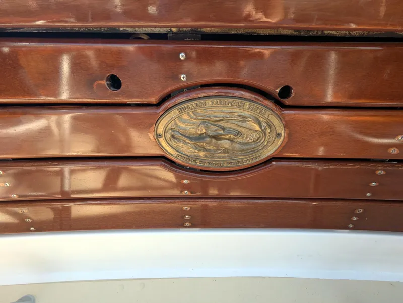 Slide: The Image of 1951 Huckins Fairform Flyer wooden boat with brass emblem detail. - 17