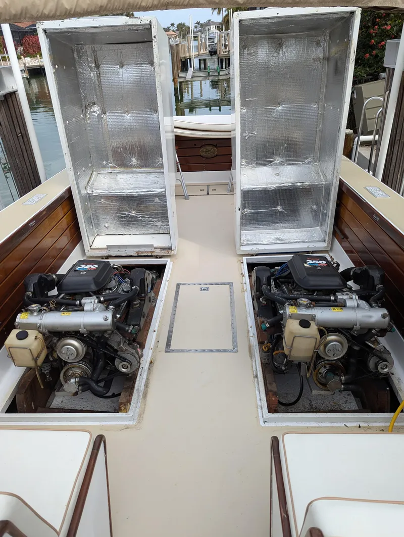 Slide: The Image of 1951 Huckins Fairform Flyer boat engines with open hatches, showcasing dual motors. - 28