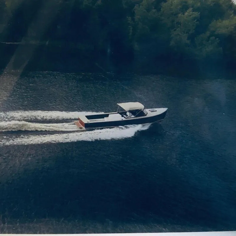 Slide: The Image of 1951 Huckins Fairform Flyer cruising on a serene waterway. - 37