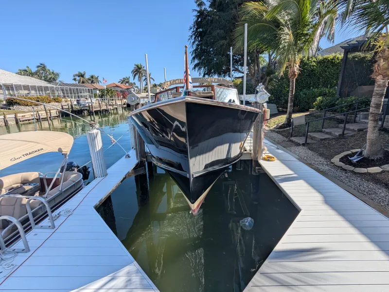 Slide: The Image of 1951 Huckins Fairform Flyer docked in a sunny marina setting. - 6
