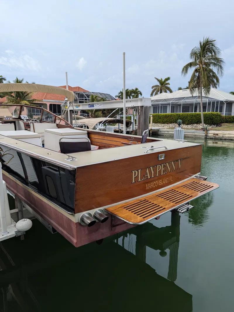 Slide: The Image of 1951 Huckins Fairform Flyer yacht docked in a serene marina setting. - 8