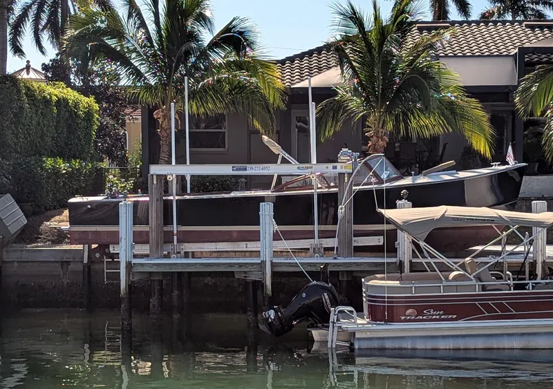 Slide: The Image of 1951 Huckins Fairform Flyer docked near palm trees and waterfront home. - 9
