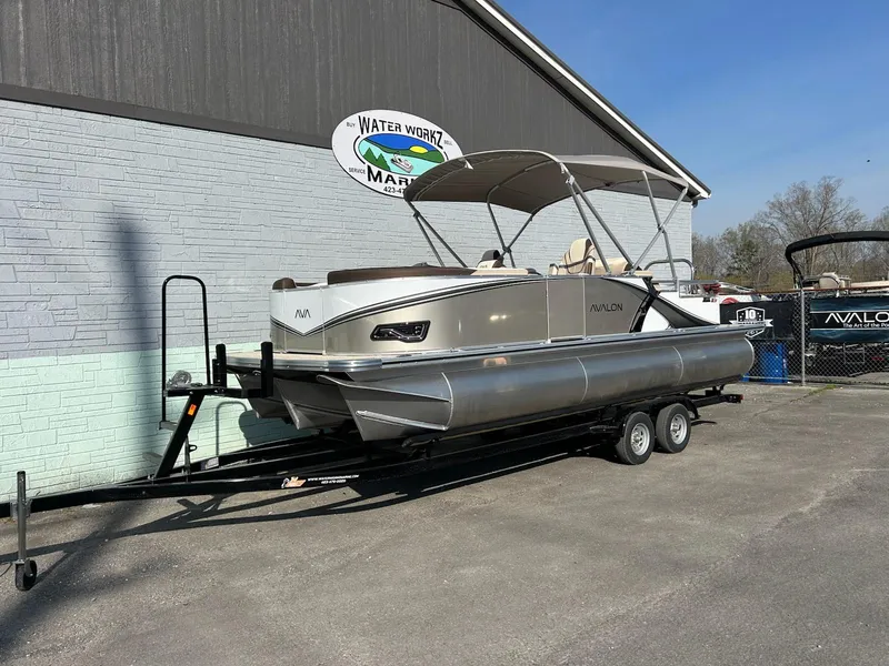 The Image of 2025 Avalon 2385 LSZ Rear Lounger pontoon boat on trailer at marina. - 0