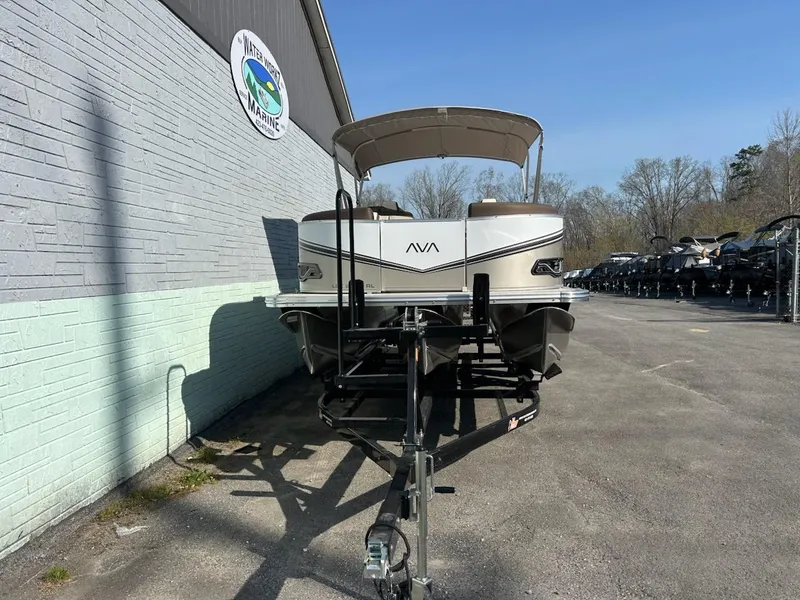 Slide: The Image of 2025 Avalon 2385 LSZ Rear Lounger pontoon boat on trailer, parked outside dealership. - 3